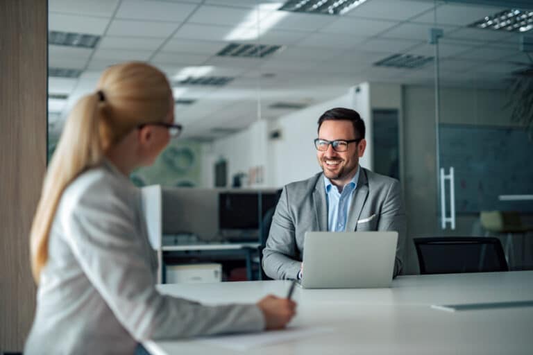 Man giving feedback to a female colleague in a successful constructive way that is being taken well