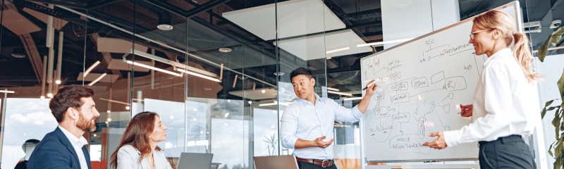 a woman and a man giving a sales presentation to senior people